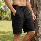 Model wearing Black 2026 Summer Jacquard Texture Sports Shorts, Trendy Casual Five-point Pants For Men outdoors - 2
