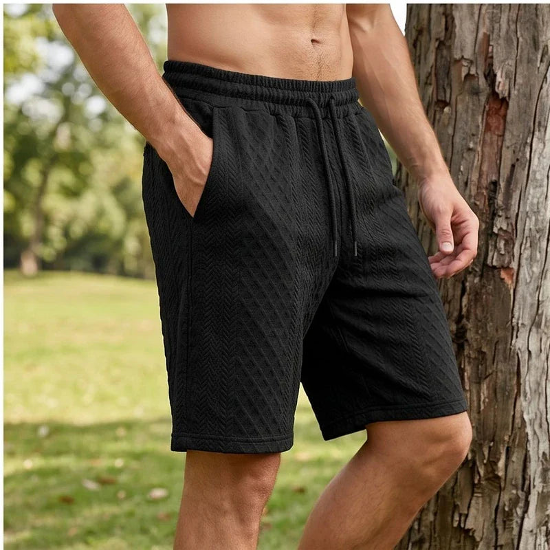 Model wearing Black 2026 Summer Jacquard Texture Sports Shorts, Trendy Casual Five-point Pants For Men outdoors - 2