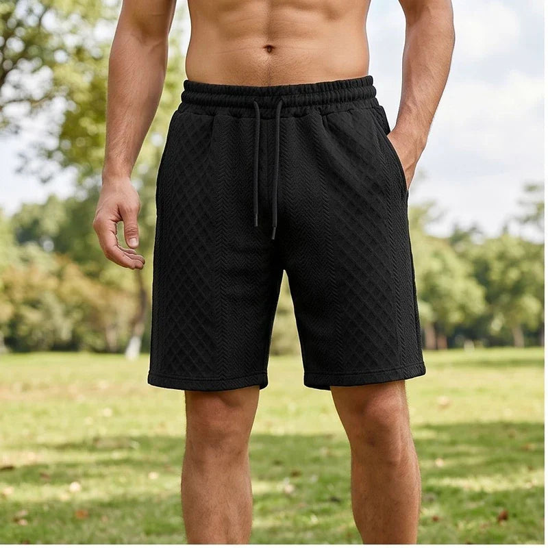 Model wearing Black 2026 Summer Jacquard Texture Sports Shorts, Trendy Casual Five-point Pants For Men outdoors