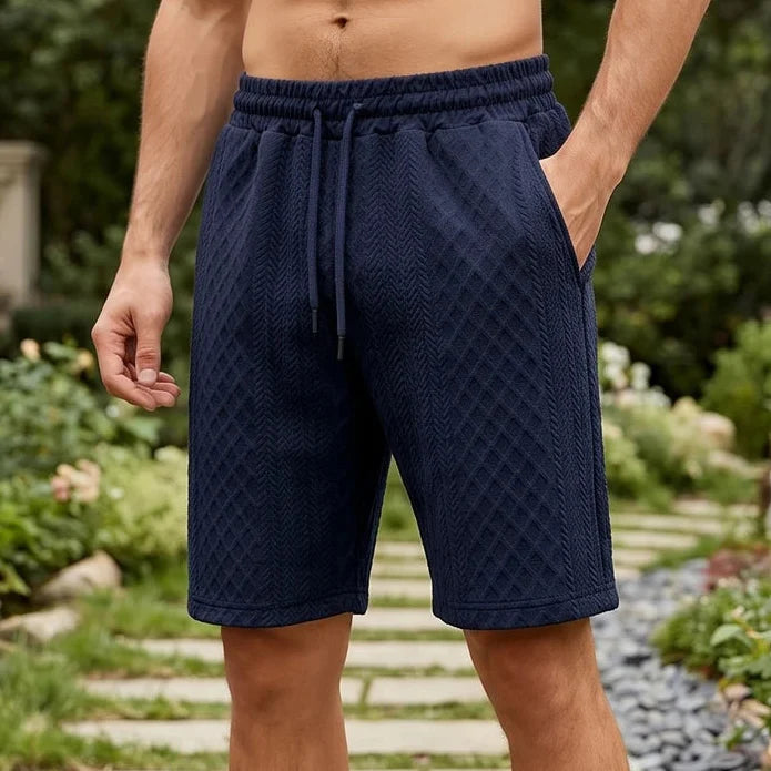 Model wearing Navy Blue 2026 Summer Jacquard Texture Sports Shorts, Trendy Casual Five-point Pants For Men outdoors
