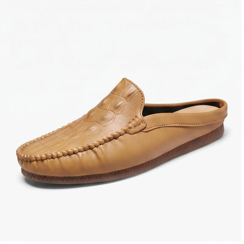 Tan leather mules on a white background