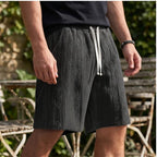 Model wearing Black 2026 New Men's Daily Jacquard Textured Fashion Casual Shorts outdoors - 2