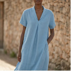 Model wearing Blue Women's Short-sleeved Cotton and Linen Dress V-neck Loose Large Size Casual Vacation Street Long Dress with Pockets outdoors