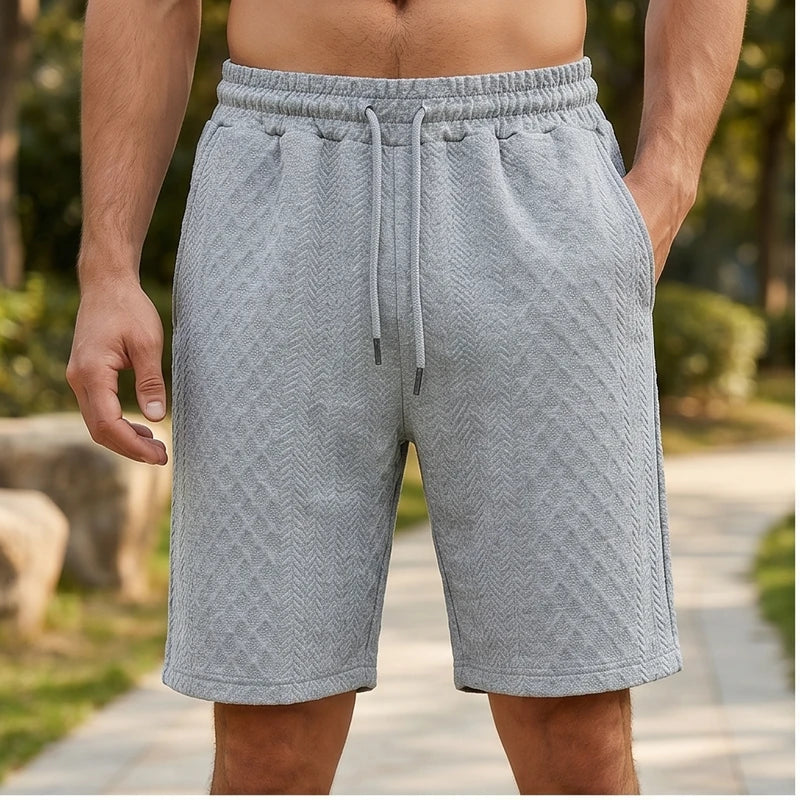 Model wearing Light Gray 2026 Summer Jacquard Texture Sports Shorts, Trendy Casual Five-point Pants For Men outdoors