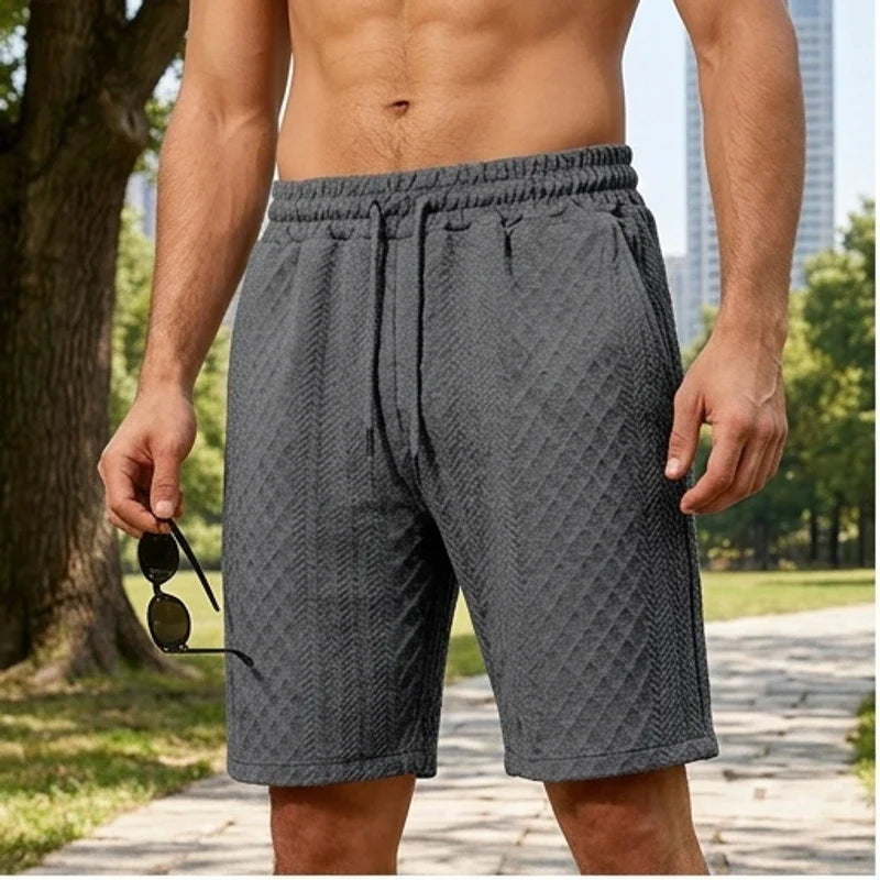 Model wearing Dark Gray 2026 Summer Jacquard Texture Sports Shorts, Trendy Casual Five-point Pants For Men outdoors