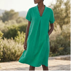 Model wearing Green Women's Short-sleeved Cotton and Linen Dress V-neck Loose Large Size Casual Vacation Street Long Dress with Pockets outdoors