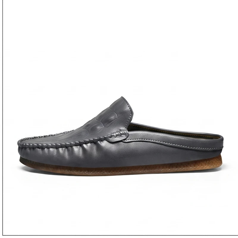 Gray leather mules on a white background