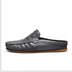 Gray leather mules on a white background