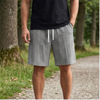 Model wearing Gray 2026 New Men's Daily Jacquard Textured Fashion Casual Shorts outdoors