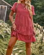 Red dotted mini sundress with ruffle short sleeves and tiered skirt.