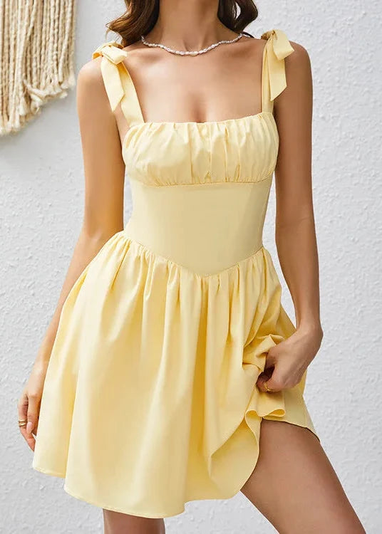 Yellow dress worn by a person against a white background