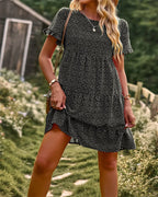 Black mini A-line sundress with white dots and short sleeves.