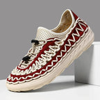 Red and cream woven waterproof sneakers with a toggle lace.