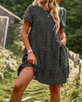Black dotted mini A-line sundress with short sleeves.