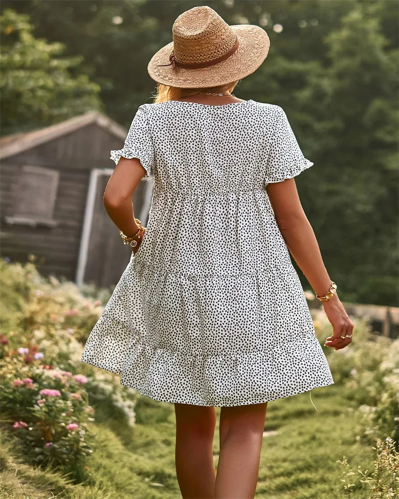 White & black dotted mini A-line sundress with short sleeves.