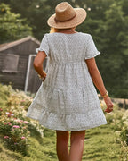White & black dotted mini A-line sundress with short sleeves.