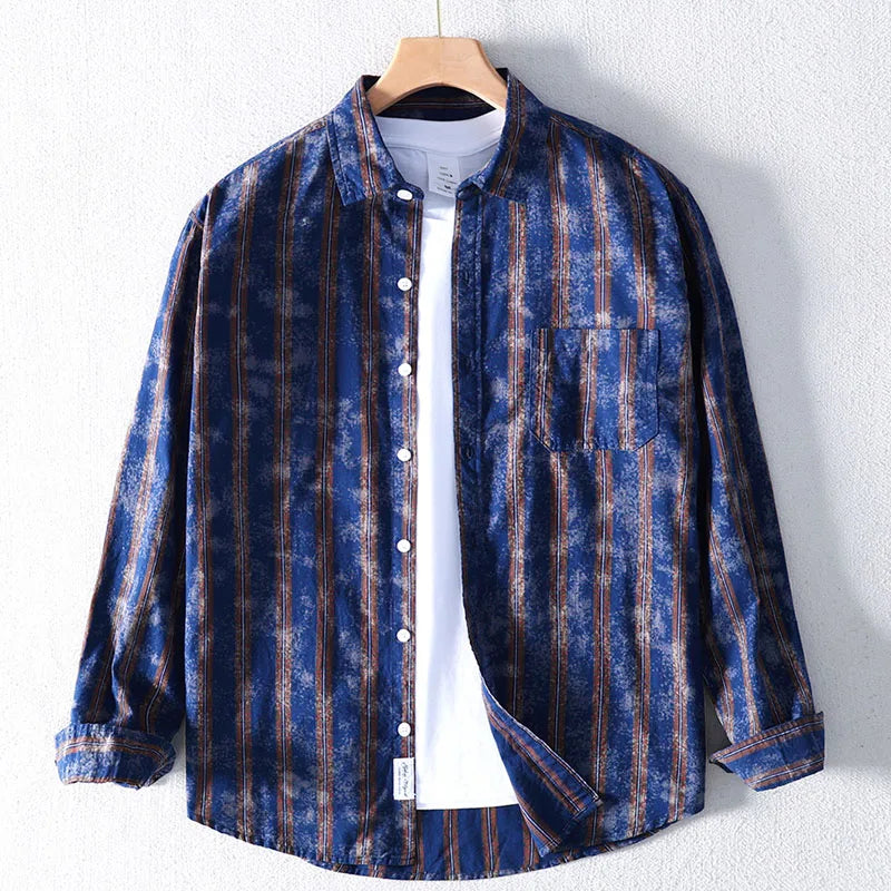 Blue and brown striped shirt on a hanger against a white background
