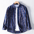 Blue and brown striped shirt on a hanger against a white background