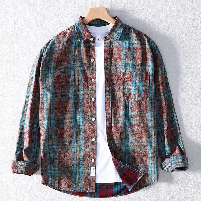 Plaid shirt on a hanger against a white background