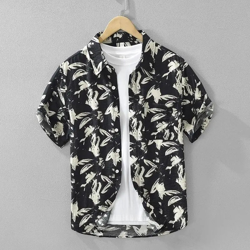 Black and white floral patterned shirt on a hanger against a gray background