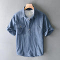 Blue striped shirt on a hanger against a gray background