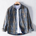 Plaid shirt on a hanger against a white background