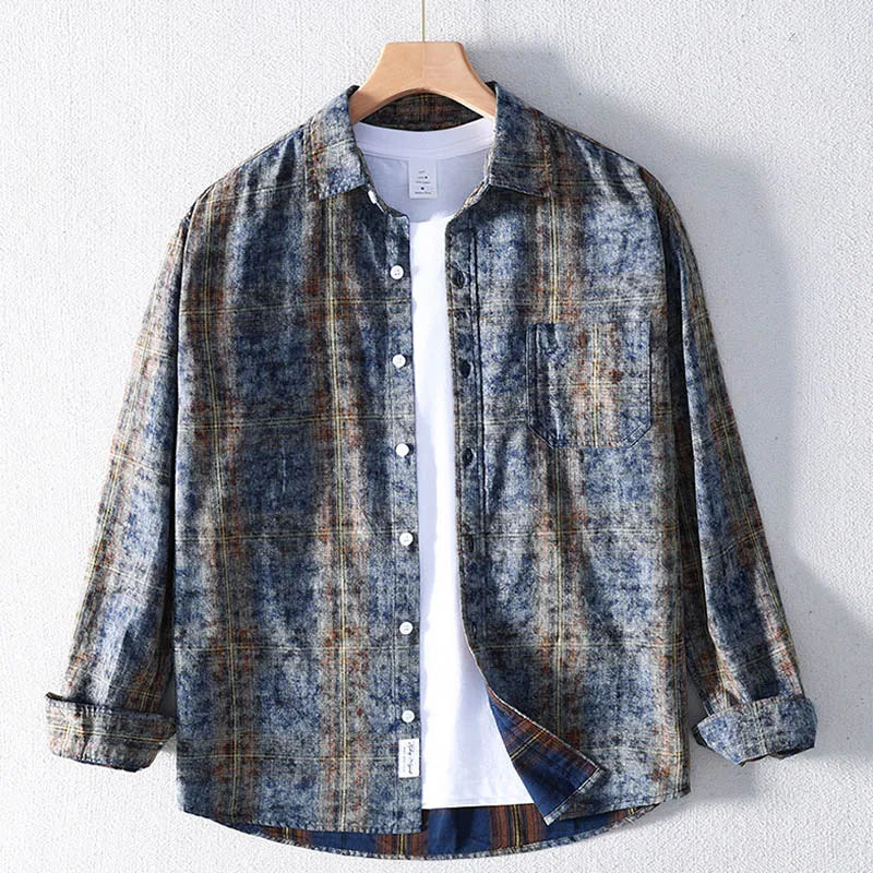 Plaid shirt on a hanger against a white background