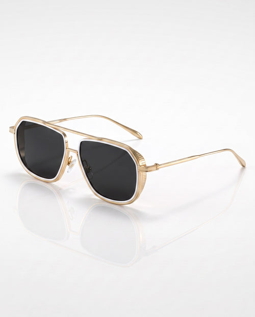 Gold-framed sunglasses with dark lenses and a white rim, angled on a reflective white surface.