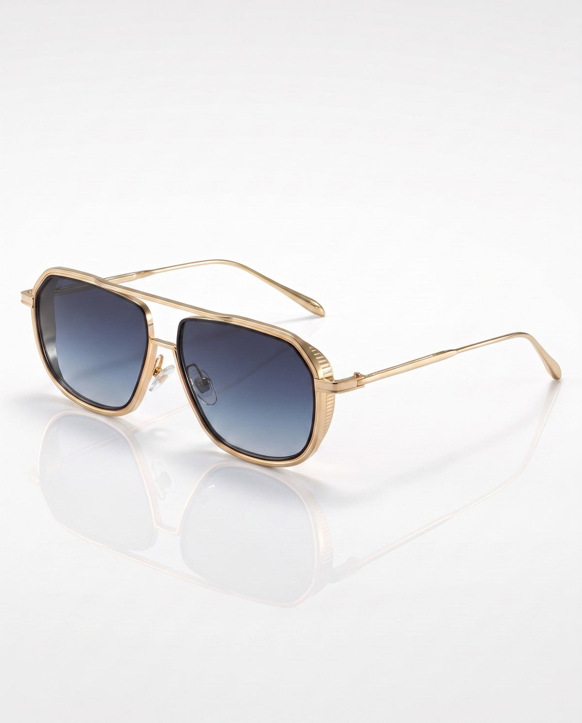 Gold-toned metal hexagonal aviator sunglasses with blue gradient lenses and ribbed details, angled on a white surface.