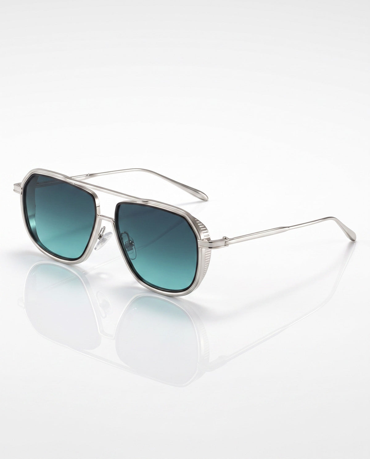 Silver aviator-style sunglasses with teal gradient lenses and silver side shields, angled on a white reflective surface.