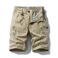 Flat lay of khaki men's shorts with an elastic drawstring waist, multiple pockets, and an unzipped fly.