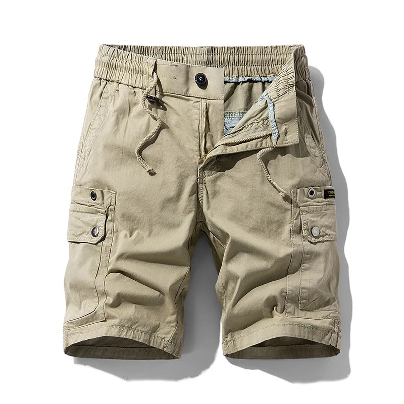 Flat lay of khaki men's shorts with an elastic drawstring waist, multiple pockets, and an unzipped fly.