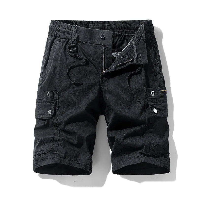 Black cargo shorts with an elastic waist, exposed zipper, and drawstring, featuring multiple flap pockets and white snap buttons.