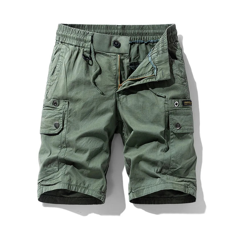 Olive green cotton cargo shorts with an elastic waistband, drawstring, unzipped fly, and buttoned side cargo pockets.