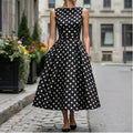 Model wearing Black Elegant Black A-Line Dress with Classic White Polka Dot Print Vintage Sleeveless Midi Dress for Formal Casual Occasions Dresses outdoors