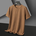 Brown waffle knit short-sleeve shirt on a hanger, displayed against a dark gray and black background.