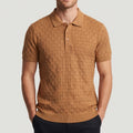 Man wearing a short-sleeved, brown knit polo with a textured checkered pattern, featuring a three-button placket and collar.