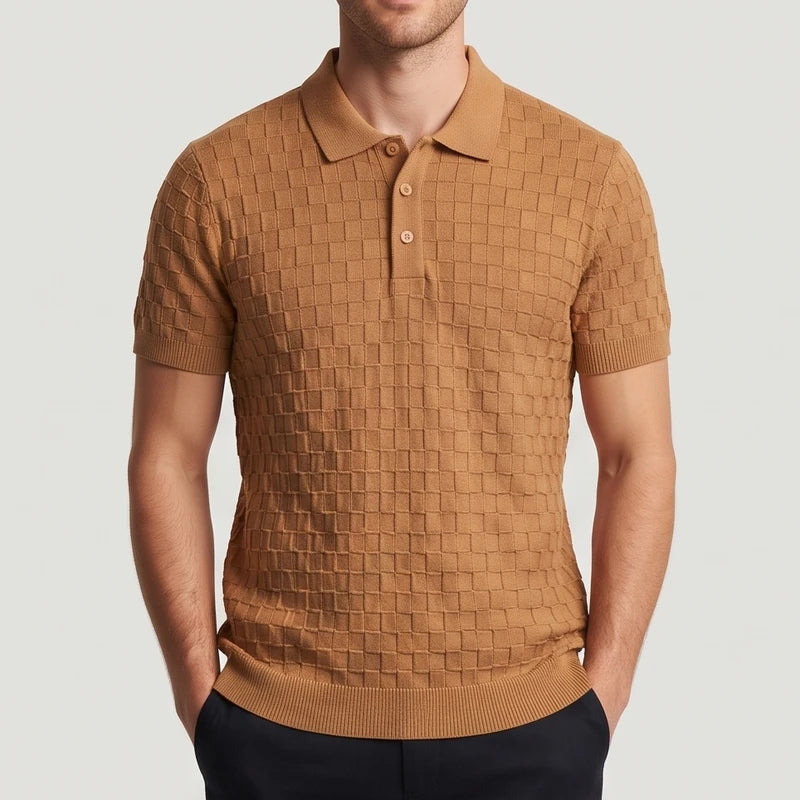 Man wearing a short-sleeved, brown knit polo with a textured checkered pattern, featuring a three-button placket and collar.
