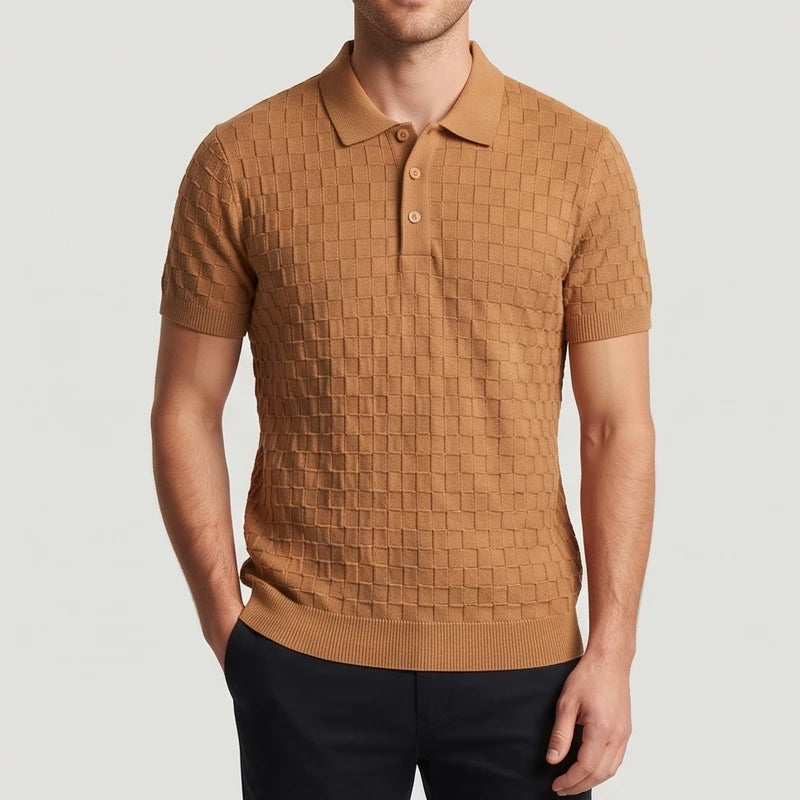 Man wearing a fitted caramel knit polo shirt with short sleeves, a spread collar, three buttons, and a prominent checkered texture.