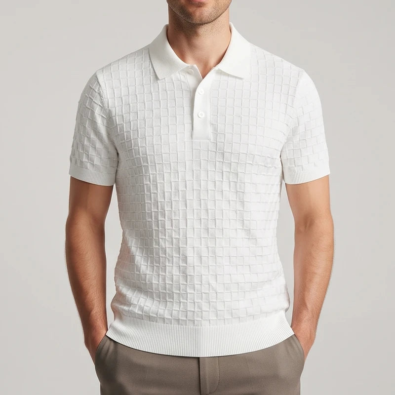 Man wearing a white short-sleeve knit polo shirt with a textured square pattern and a two-button placket.