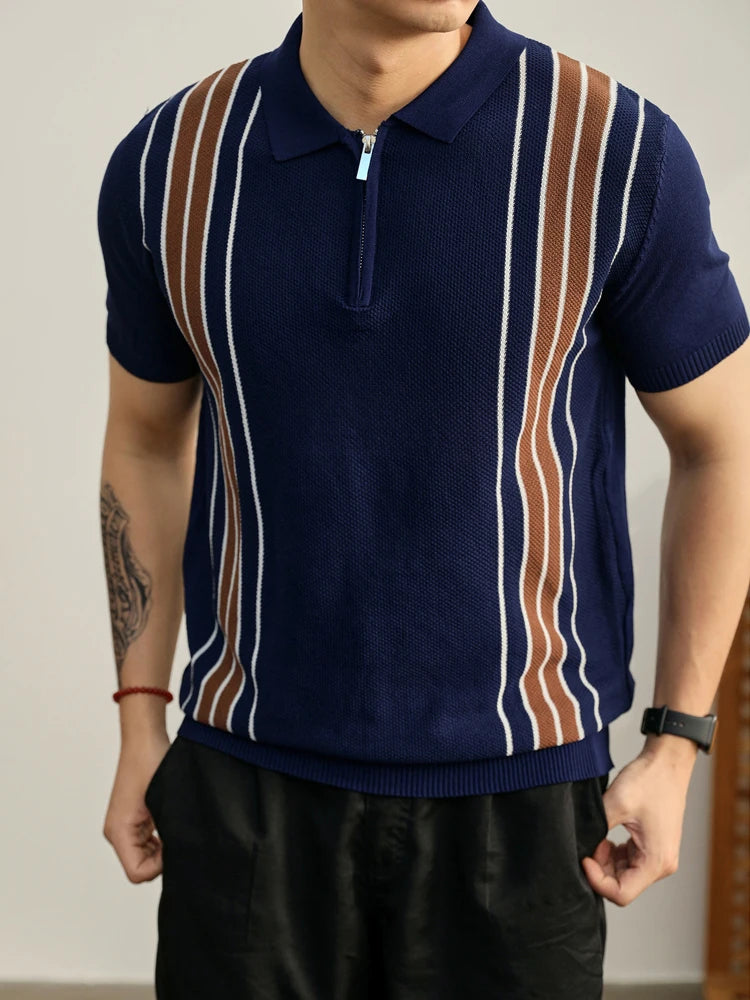 Man wearing a navy blue knit polo shirt with vertical brown and white stripes and a silver-toned zipper placket.