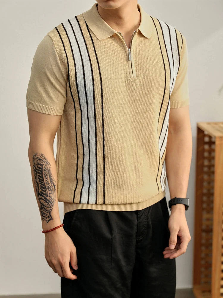 Man wearing a short-sleeve knit polo shirt in tan with white and black vertical stripes and a silver zipper placket.