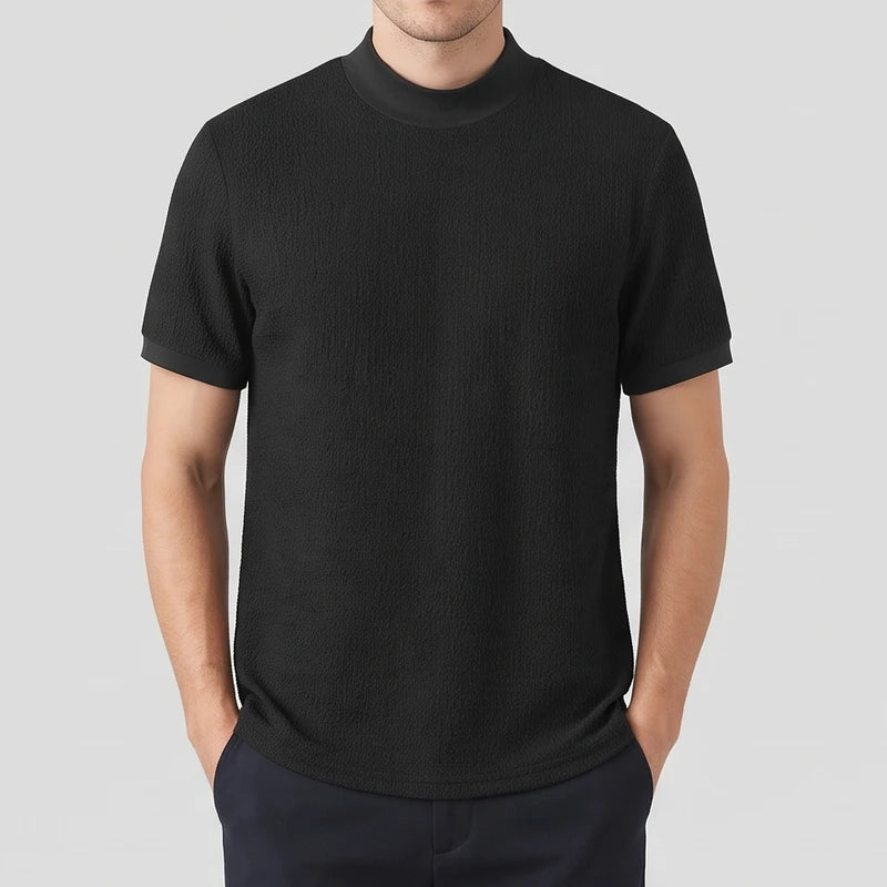 Black knit shirt on an off-gray studio background