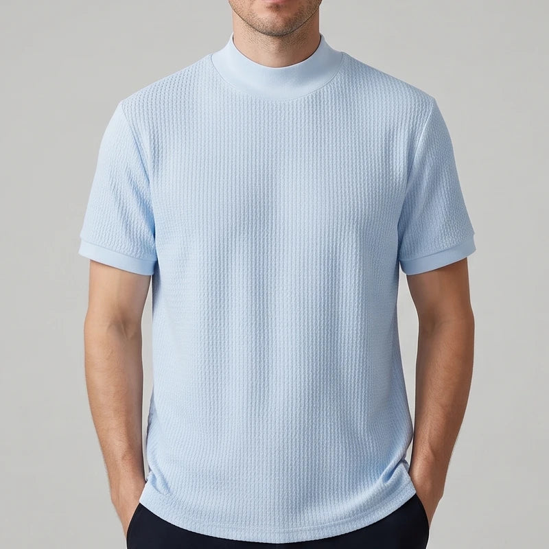 Blue knit shirt on an off-gray studio background