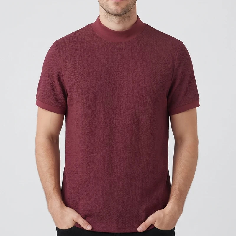 Burgundy knit shirt on an off-gray studio background