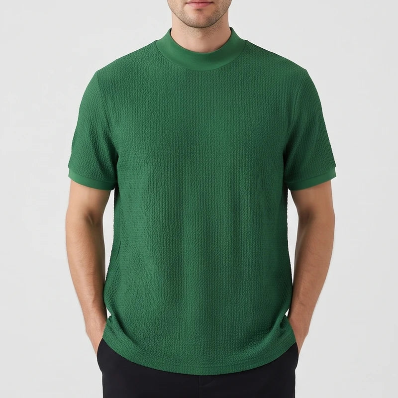 Green knit shirt on an off-gray studio background