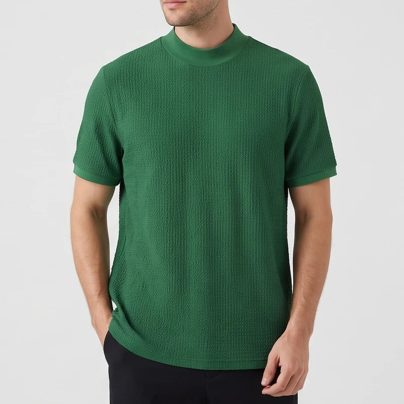 Green knit shirt on an off-gray studio background - 2