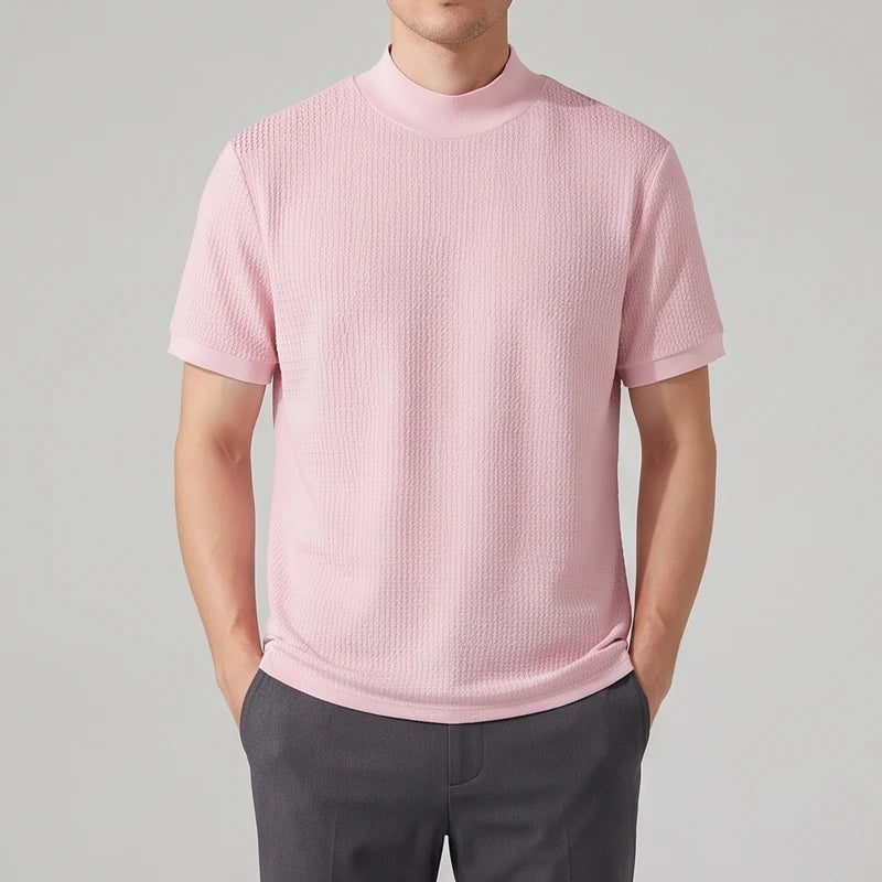 Pink knit shirt on an off-gray studio background