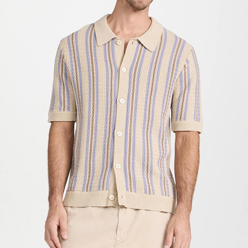 Man wearing a short-sleeve knit shirt with beige, purple, and brown vertical stripes, unbuttoned over a solid beige shirt.