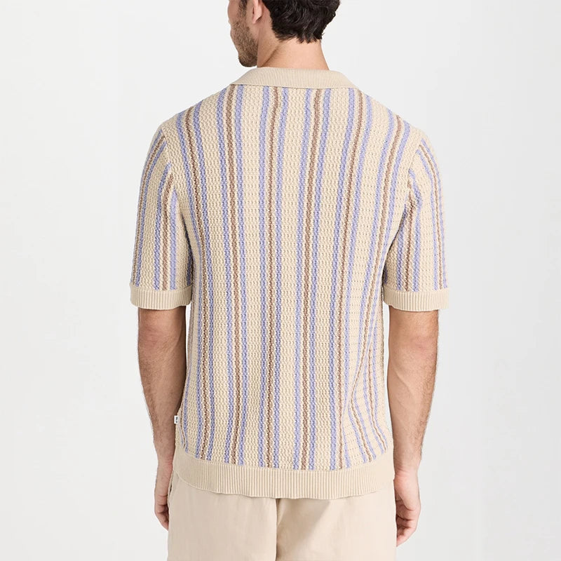 Man wearing a beige knit short-sleeve shirt with purple and brown vertical stripes, viewed from the back.